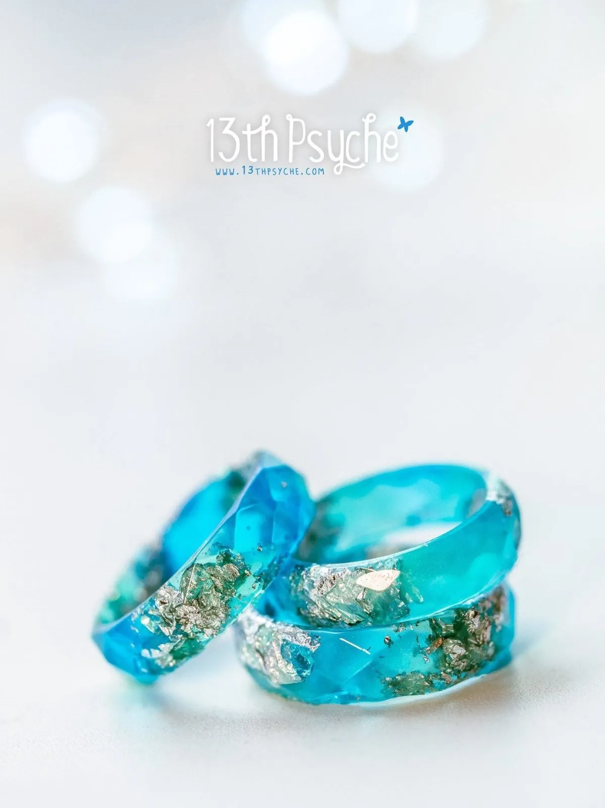 Clear blue and turquoise faceted resin ring with silver flakes