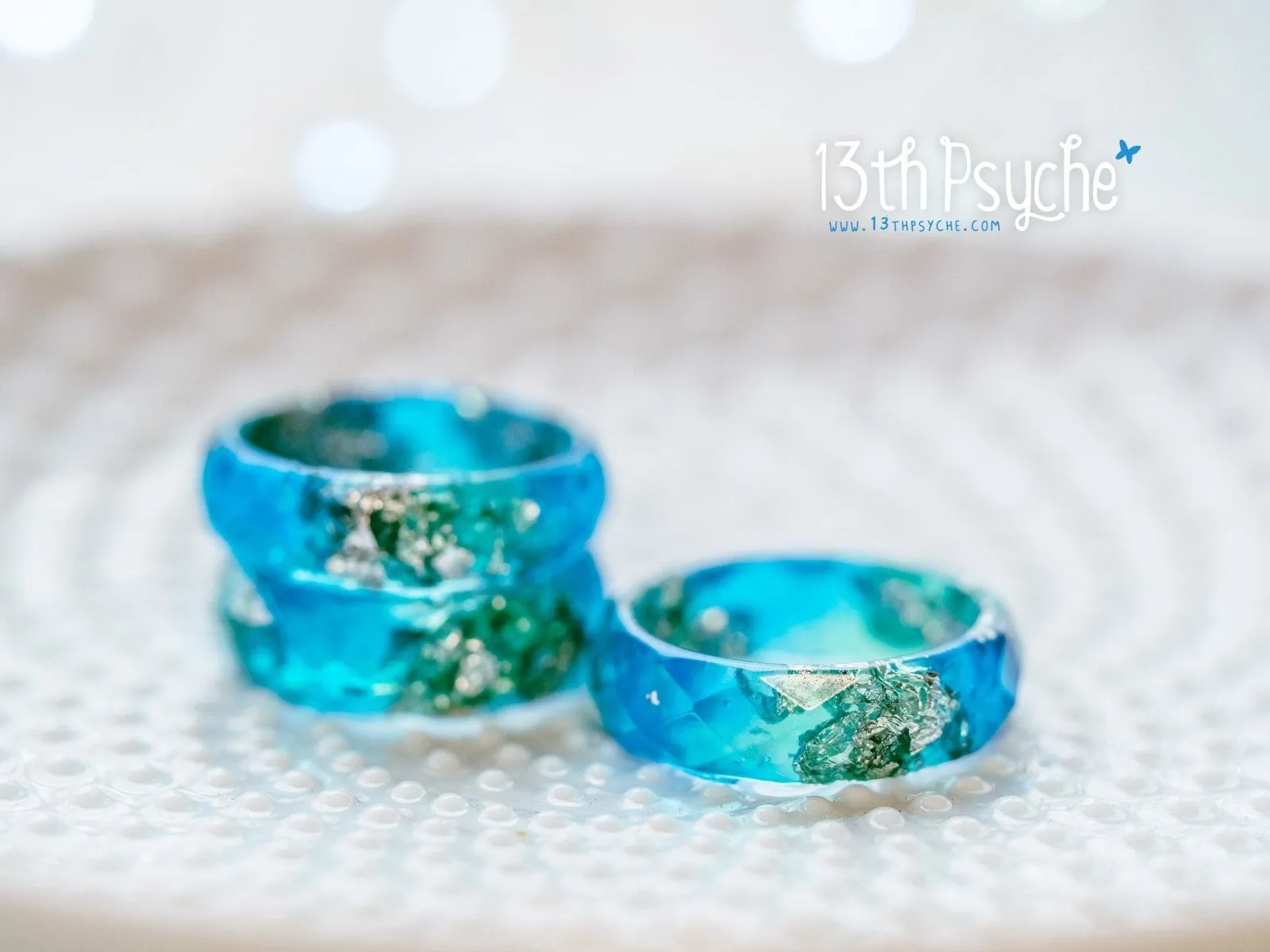 Clear blue and turquoise faceted resin ring with silver flakes